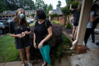 Middle school student Meredith Rogers, left, waits outside the DeKalb Pediatric Center after receiving her first coronavirus vaccination on Wednesday, May 12, 2021, in Decatur, Ga. Hundreds of children, ages 12 to 15, received the Pfizer vaccine at the center, just days after it was approved for use within their age group. (AP Photo/Ron Harris)