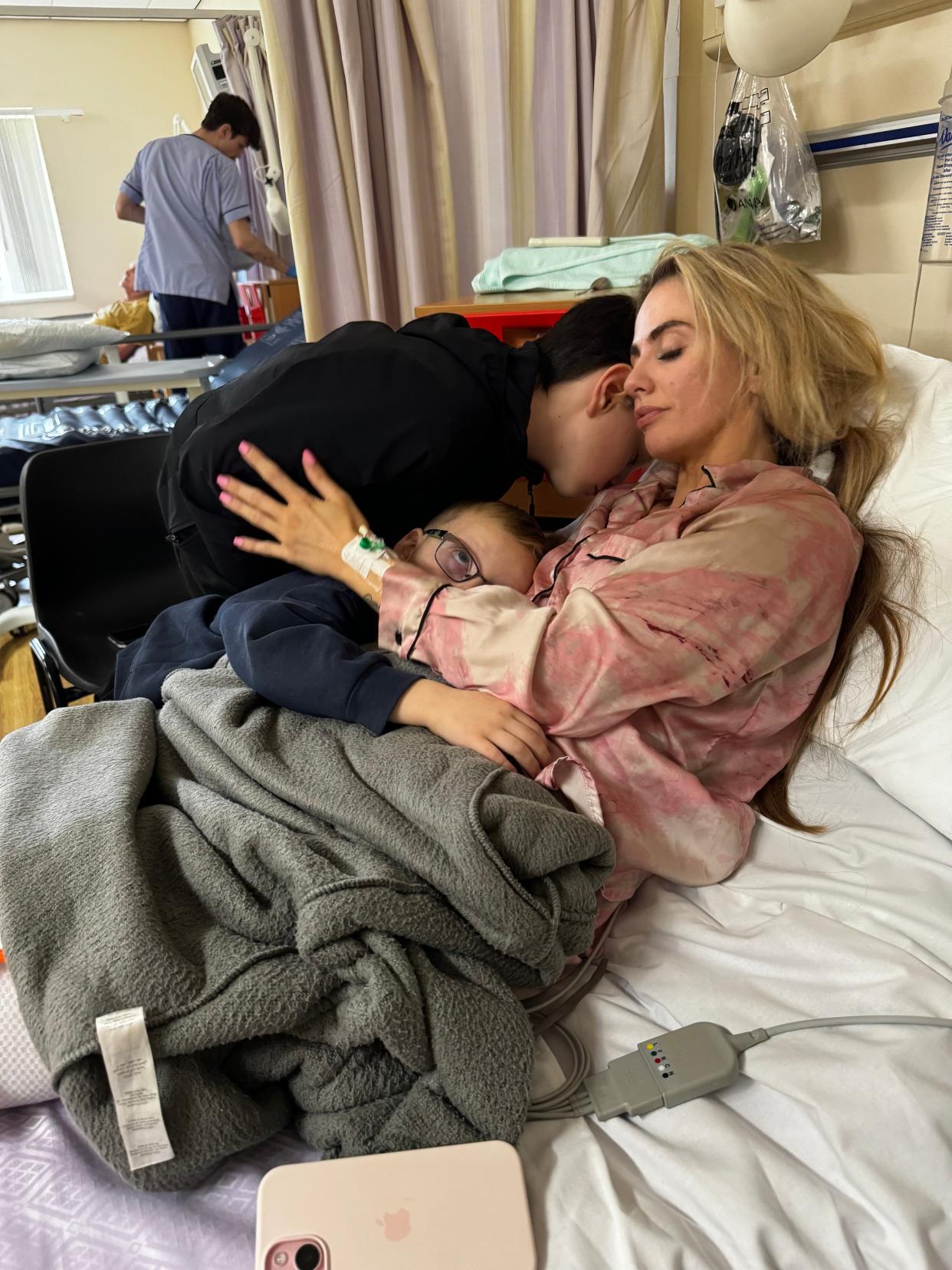 Jess Tierney in hospital with her sons after her stroke. (PA)