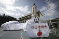 A person stands inside a Portable Epidemiological Insulation Unit during a media presentation, in Bogota, Colombia, Tuesday, Feb. 16, 2021. Colombia’s La Salle University school of architecture designed the small polyhedral pneumatic geodesic domes which can be used to isolate and treat COVID-19 patients in areas where there are no nearby hospitals or where existing hospitals are overwhelmed with patients. (AP Photo/Fernando Vergara)