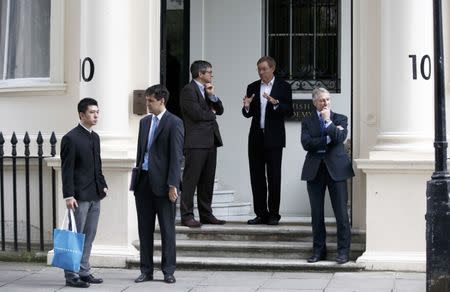 People stand outside 10 Carlton House Terrace in central London, where representatives from Britain, China, France and energy company EDF will sign an agreement to build and operate a new nuclear power station at Hinkley Point, Britain, September 29, 2016. REUTERS/Peter Nicholls