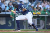 Seattle Mariners' Julio Rodriguez is hit by a pitch fom Oakland Athletics starting pitcher Adrian Martinez during the first inning of a baseball game, Thursday, June 30, 2022, in Seattle. (AP Photo/John Froschauer)