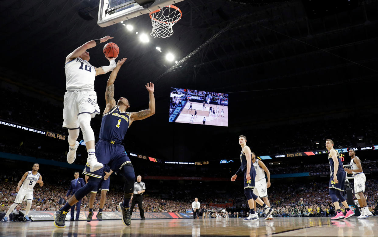 Villanova’s Donte DiVincenzo (10) goes up for a shot over Michigan’s Charles Matthews (1) during the second half in the championship game of the Final Four NCAA college basketball tournament, Monday, April 2, 2018, in San Antonio. (AP Photo/David J. Phillip)