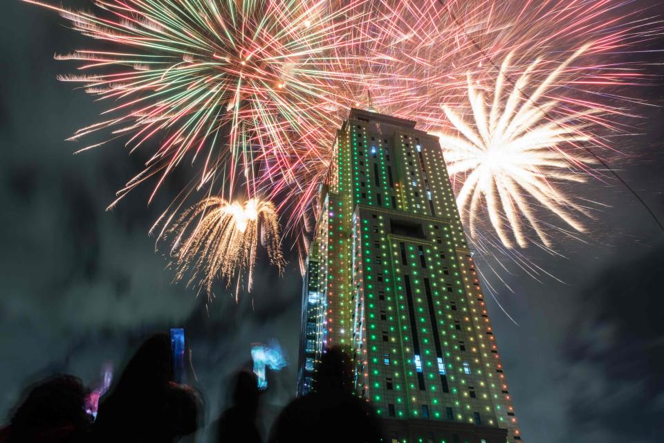 People look at fireworks launching from the building of Old Mutual Tower to celebrate the new year in Nairobi (AFP via Getty Images)