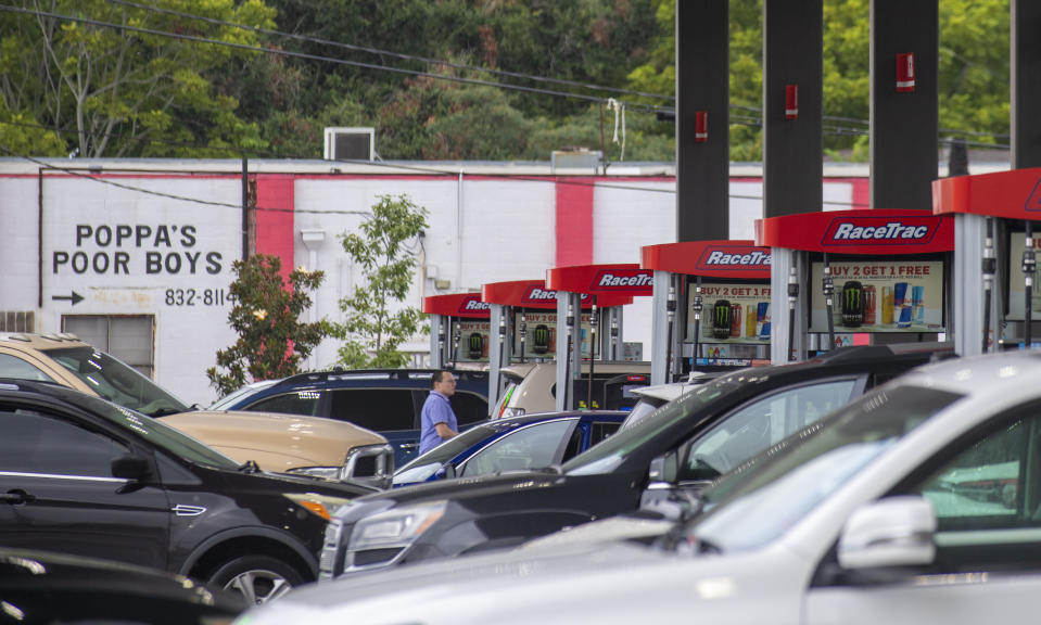 Long lines are seen at a gas station in Jefferson, La., as people prepare for the arrival of Hurricane Ida on Friday, Aug. 27, 2021. Forecasters now say Ida could be a major Category 3 hurricane with top winds of 115 mph when it nears the U.S. coast. (Chris Granger/The Times-Picayune/The New Orleans Advocate via AP)