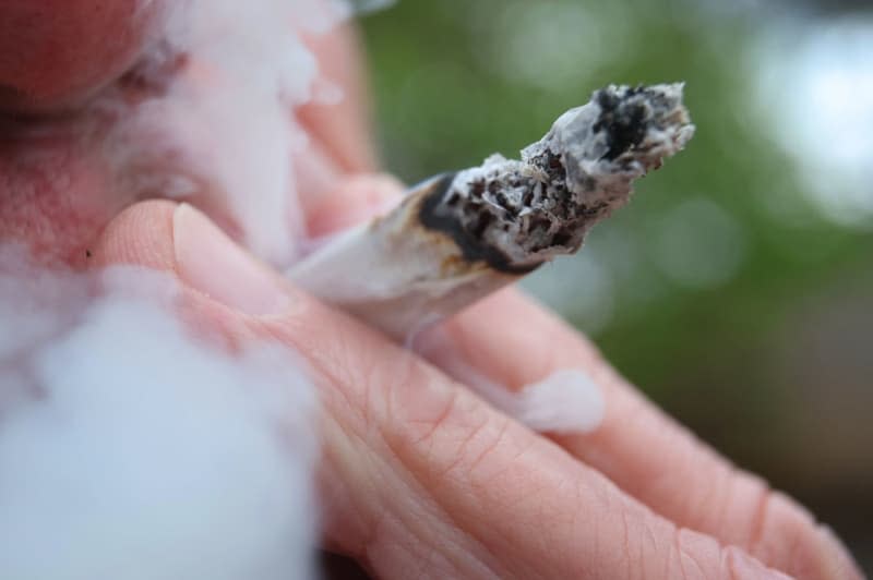 An outdoor weed smoker. As of April 1, this is allowed in Germany, though not near places where children congregate. Karl-Josef Hildenbrand/dpa