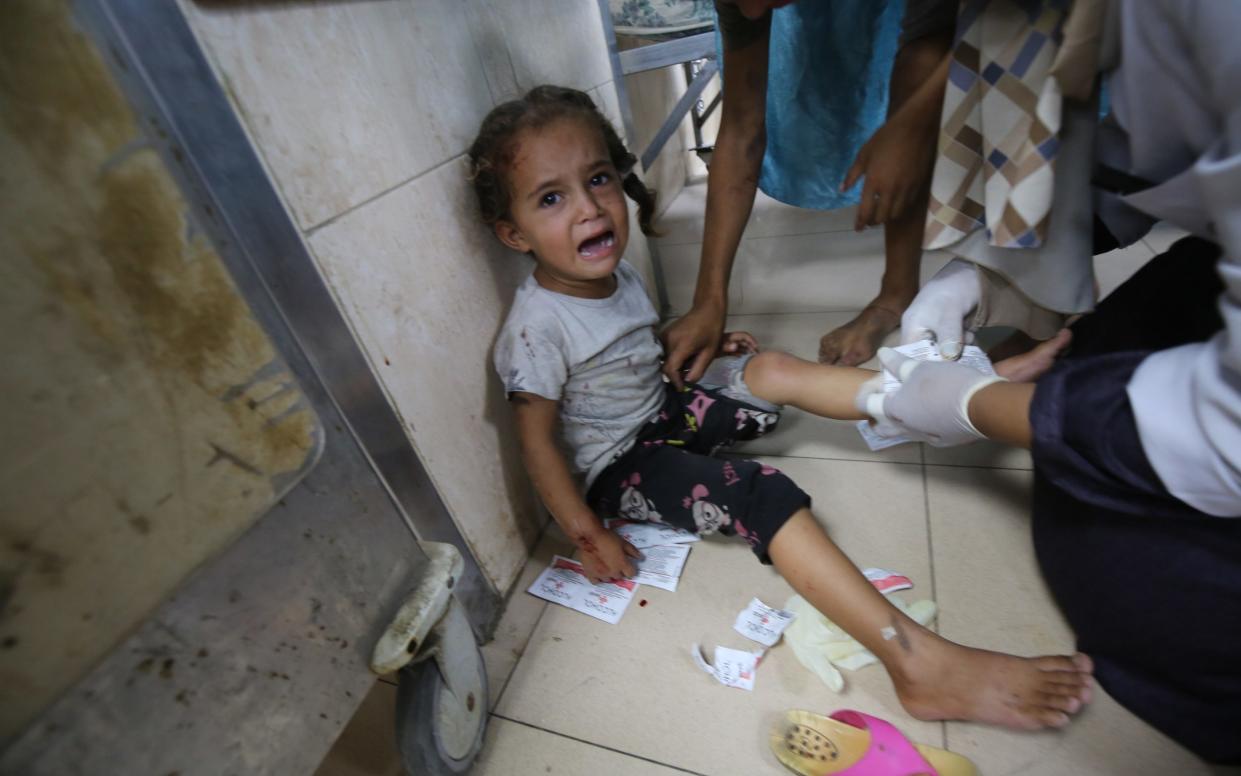 Injured Palestinians, including children, are brought to Al-Aqsa Hospital to receive medical treatment after the IDF operation