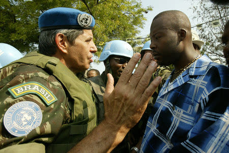 FILE PHOTO: Brazilian General Augusto Heleno Periera (L) talks to the leader of a group of supporters of former Haitian President Jean-Bertrand Aristide about the route they should take before a demonstration by several thousand Arsitide supporters held on March 29, 2005, the 18th anniversary of the country's constitution, in Port-au-Prince, Haiti REUTERS/Daniel Morel/File photo