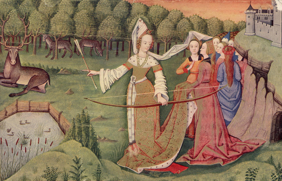 Circa 1450, a group of ladies on the grounds of a castle watch one of their number as she prepares to shoot a stag with a bow and arrow. <cite>Hulton Archive/Getty</cite>