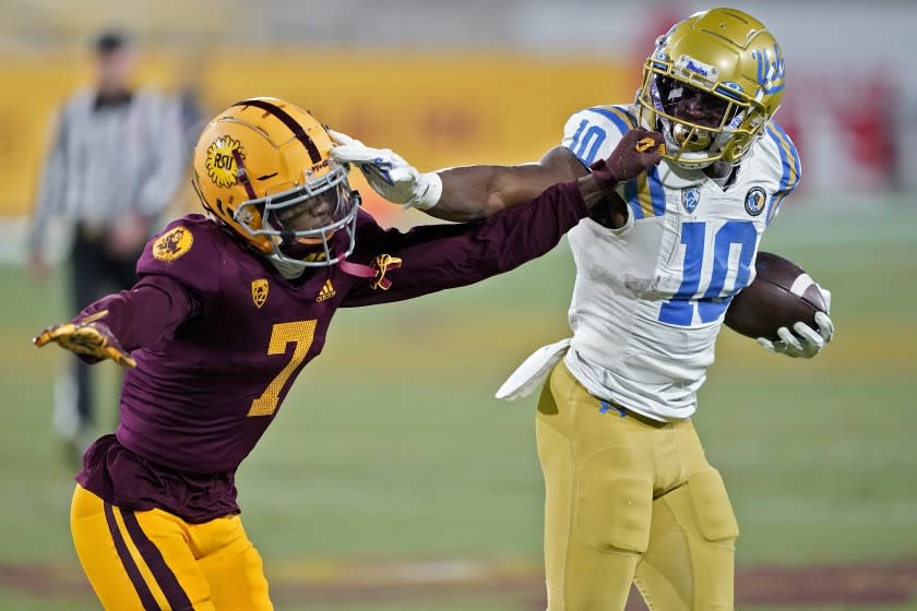 UCLA running back Demetric Felton (10) runs as Arizona State tight end Ethan Long (7) gets called for a face mask defends during the second half of an NCAA college football game, Saturday, Dec. 5, 2020, in Tempe, Ariz. UCLA won 25-18. (AP Photo/Matt York)