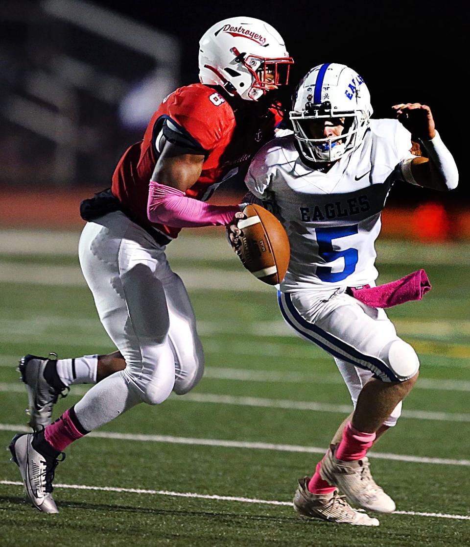 South Hunterdon quarterback Anthony Venettone runs as Dunellen's Chiekezie Ogbuewu goes for the tackle in the football game on Oct. 6, 2023