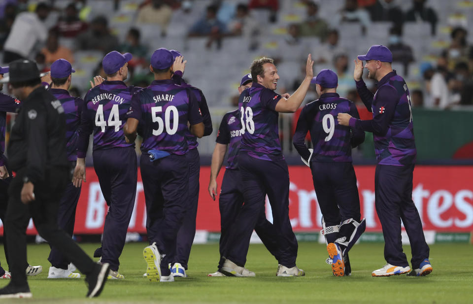 Scotland's bowler Josh Davey, third from right, celebrates with teammates after dismissing Bangladesh's batsman Soumya Sarkar for 5 runs during the Cricket Twenty20 World Cup first round match between Bangladesh and Scotland in Muscat, Oman, Sunday, Oct. 17, 2021. (AP Photo/Kamran Jebreili)