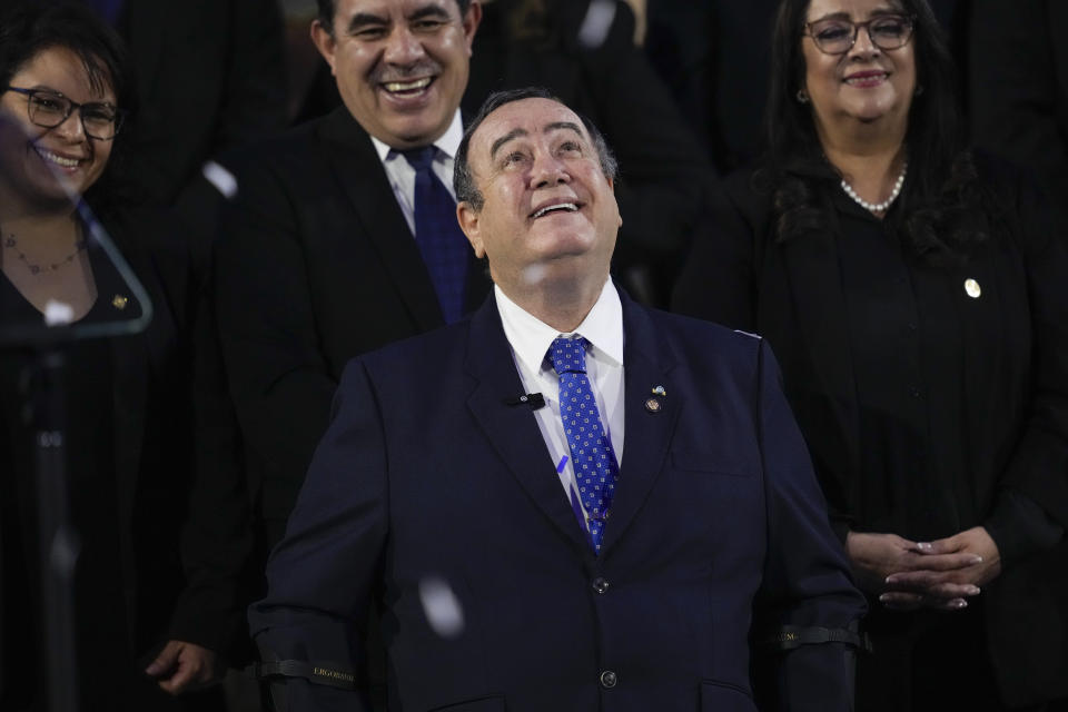 Outgoing Guatemalan President Alejandro Giammattei smiles after delivering his annual report at the National Palace in Guatemala City, Friday, Jan. 12, 2024. Giammattei ends his four year term on Sunday. (AP Photo/Moises Castillo)