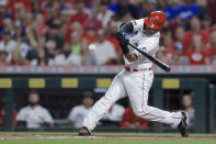 Cincinnati Reds' Tucker Barnhart hits an RBI single during the fifth inning of the team's baseball game against the Los Angeles Dodgers in Cincinnati, Friday, Sept. 17, 2021. (AP Photo/Aaron Doster)