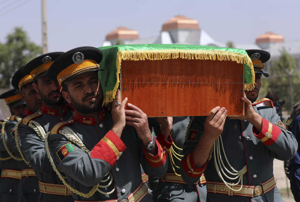 Afghan honor guards carry the coffin of Dawa Khan Menapal, director of Afghanistan's Government Information Media Center who was shot and killed in Kabul, Afghanistan, Saturday, Aug. 7, 2021. The Taliban shot and killed the director of Afghanistan's Government Information Media Center on Friday, the latest killing of a government official and one that comes just days after an assassination attempt on the acting defense minister. (AP Photo/Rahmat Gul)