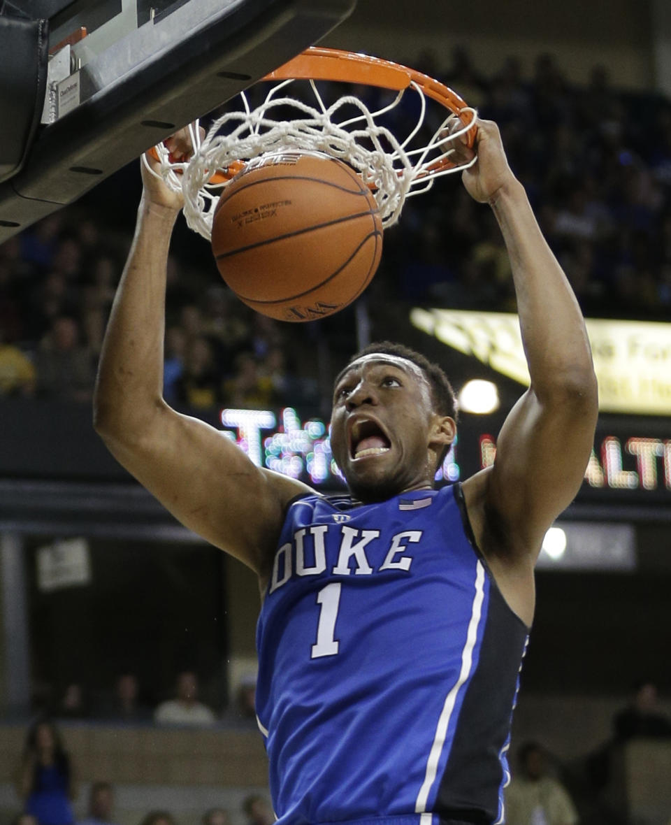 FILE - In this March 5, 2014 film photo, Duke's Jabari Parker (1) dunks against Wake Forest during the second half of an NCAA college basketball game in Winston-Salem, N.C. Parker was selected to The Associated Press All-America team, released Monday, March 31, 2014. (AP Photo/Chuck Burton)