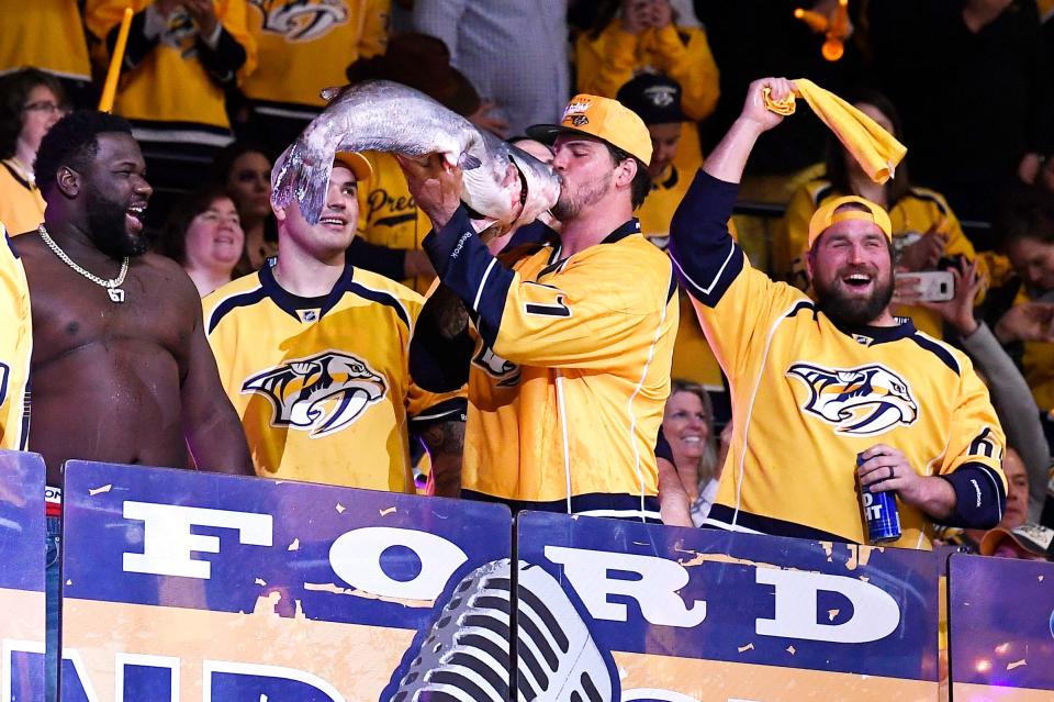 Titans offensive tackle Taylor Lewan kisses a catfish during pregame festivities before Game 2 against the Jets of the second round NHL Stanley Cup Playoffs at the Bridgestone Arena Sunday, April 29, 2018, in Nashville, Tenn.