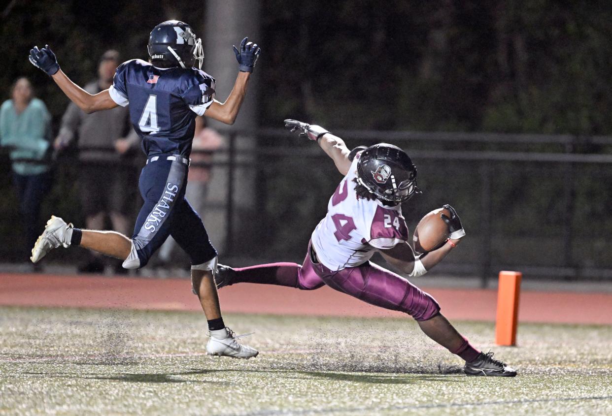 Cape Tech runningback Rovens Jean-Baptiste crosses the goallinr past at Monomoy defender Jayden Daluze-Starks for the game winning touchdown.