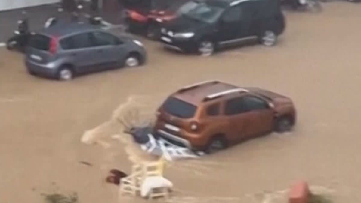 Roads on Greek island of Skiathos turned to rushing rivers after intense rainfall (AP)