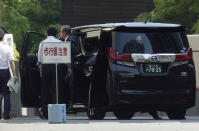 Former Nissan chairman Carlos Ghosn, right, gets off a car as he arrives at Tokyo District Court for a pre-trial meeting Thursday, May 23, 2019, in Tokyo. Ghosn, who is out on bail, has been charged with under-reporting his post-retirement compensation and breach of trust in diverting Nissan money and allegedly having it shoulder his personal investment losses. (AP Photo/Eugene Hoshiko)