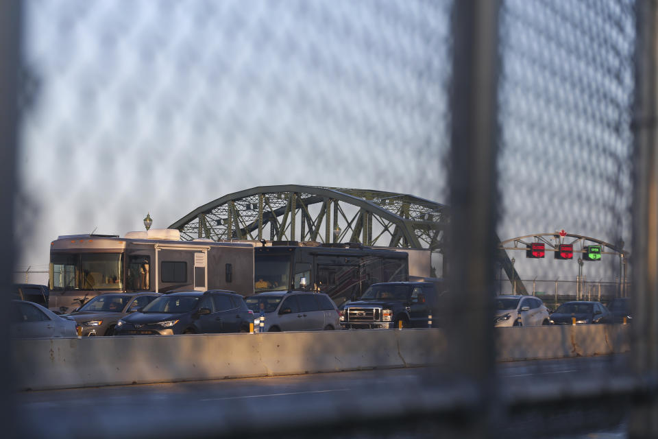 <p>Cars line up at a checkpoint after crossing the Peace Bridge into the United States from Canada in Buffalo, N.Y., Monday, Nov. 8, 2021. (AP Photo/Joshua Bessex)</p> 