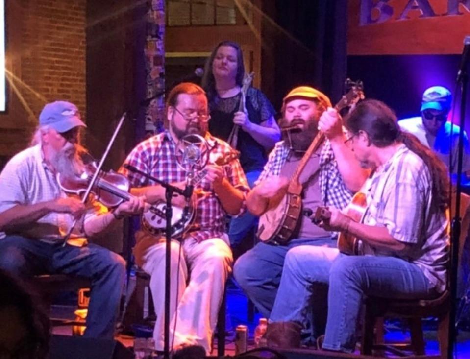 Kenzo Bronson (fiddle), Stirling Walsh (hybrid cross between a banjo and ukulele), April Hamilton (washed up bass), Drew Fisher and Buck Hoffmann (guitar) in the Tennessee Stringbusters.