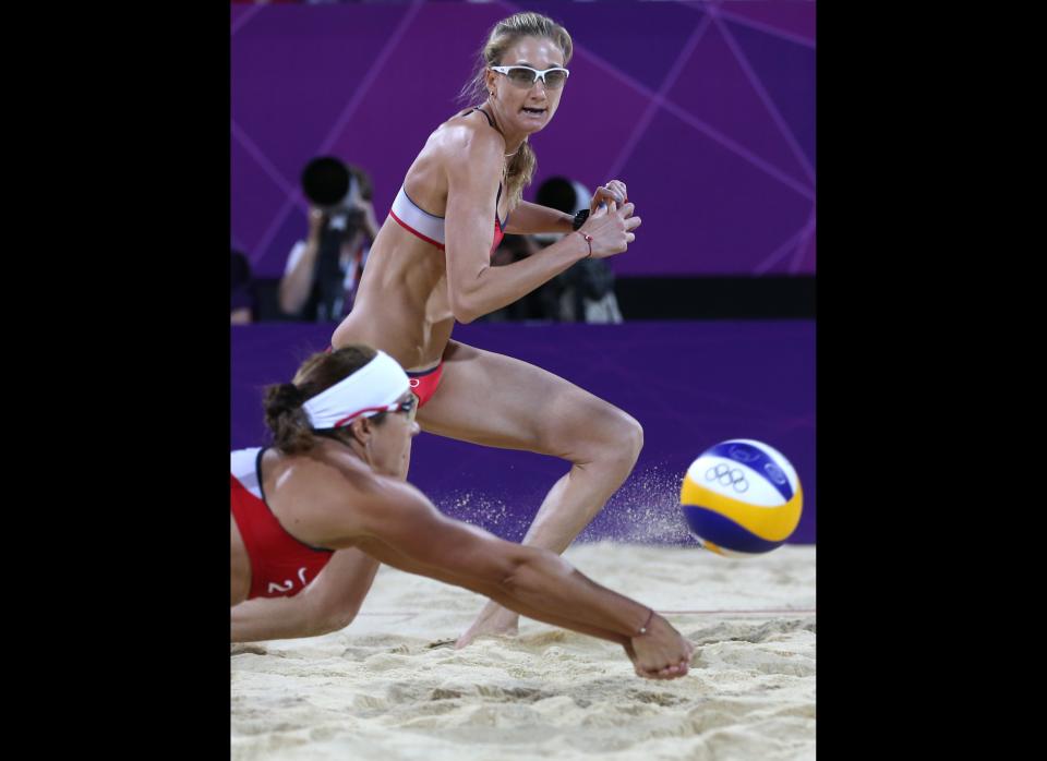 United States' Kerri Walsh Jennings, right, looks on as Misty May-Treanor, left, dives for a ball during the women's gold medal beach volleyball match against the other US team at the 2012 Summer Olympics, Wednesday, Aug. 8, 2012, in London. 