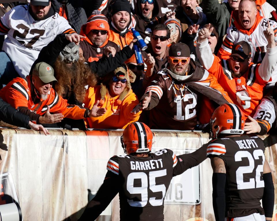 Cleveland Browns defensive end Myles Garrett (95) celebrates with fans after scoring a touchdown during the first half of an NFL football game against the Baltimore Ravens, Sunday, Dec. 12, 2021, in Cleveland. (AP Photo/Ron Schwane)