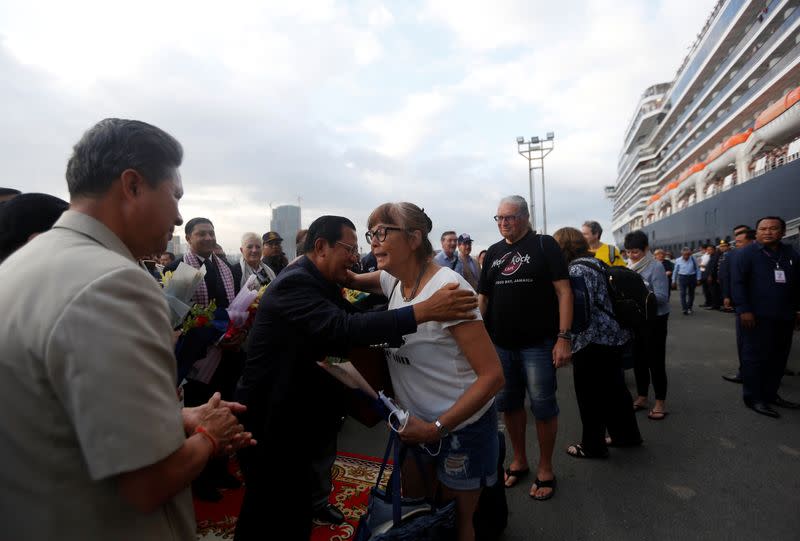 Cambodia's Prime Minister Hun Sen welcomes passenger of MS Westerdam, a cruise ship that spent two weeks at sea after being turned away by five countries over fears that someone aboard might have the coronavirus, as it docks in Sihanoukville