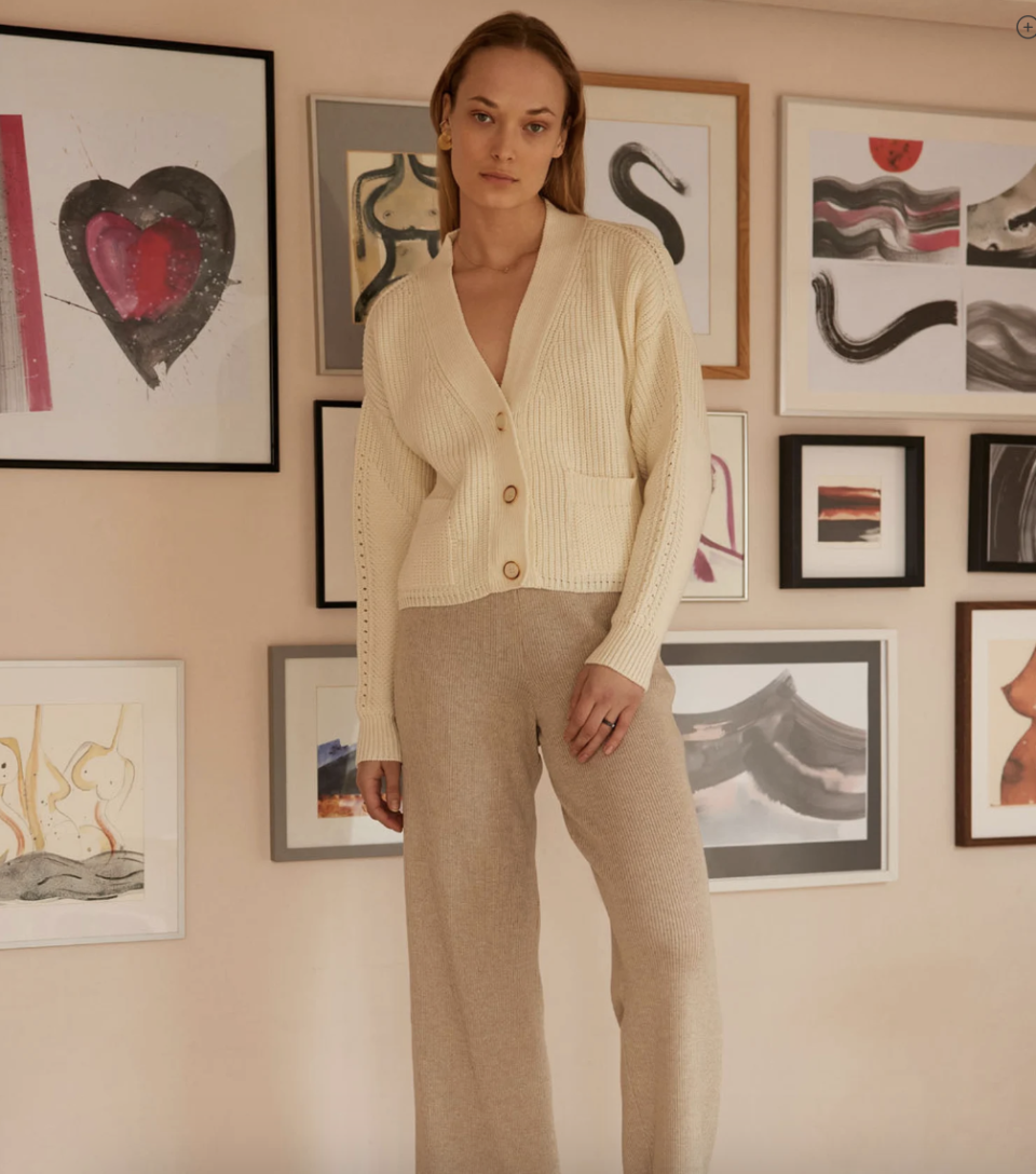 model wearing white merino wool cardigan with oatmeal pants