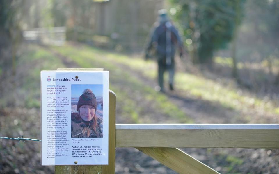 A missing person notice attached to a gate where officers are searching for Nicola Bulley - Peter Byrne