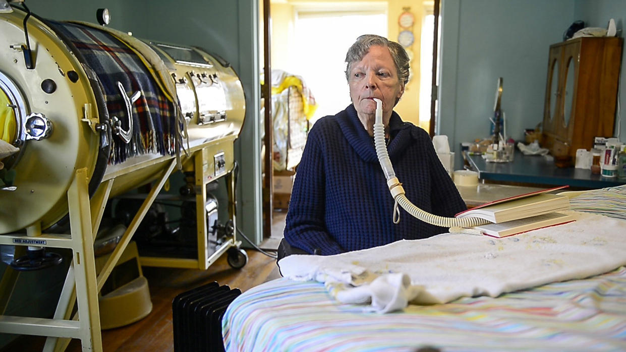 Polio patient Mona Randolph uses a respirator in 2018 to help her breathe. Randolph, who died in 2019, was also one of the last remaining users in the U.S. of an iron lung.