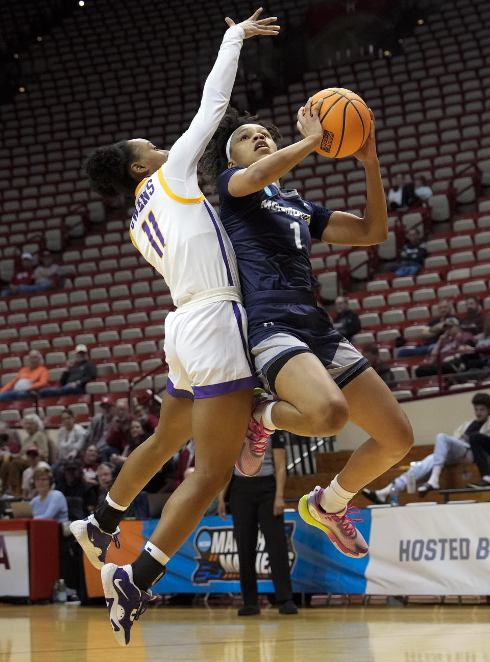 Monmouth guard Ariana Vanderhoop (1) shoots against Tennessee Tech guard Maaliya Owens (11) during the first half of a First Four college basketball game in the NCAA women's Basketball Tournament in Bloomington, Ind., Thursday, March 16, 2023. (AP Photo/AJ Mast)