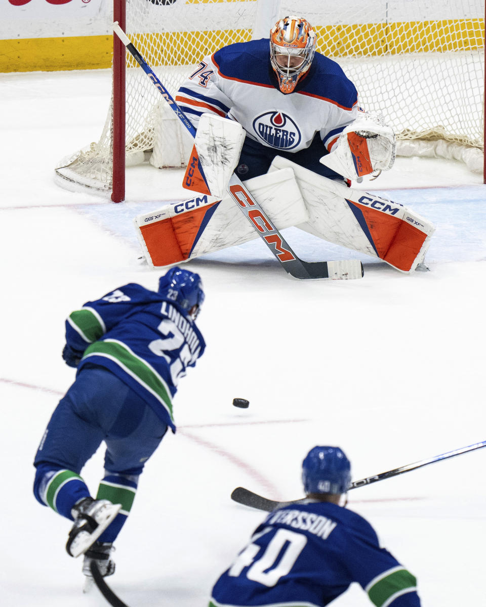 Vancouver Canucks' Elias Lindholm shoots the puck at Edmonton Oilers goalie Stuart Skinner during the second period of Game 1 of a second-round NHL hockey Stanley Cup playoffs series, Wednesday, May 8, 2024, in Vancouver, British Columbia. (Ethan Cairns/The Canadian Press via AP)