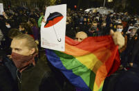 A crowd gathers outside the house of Poland's ruling conservative party leader Jaroslaw Kaczynski in Warsaw, Poland, Friday, Oct. 23, 2020. Protesters vented anger for a second day across Poland over a court ruling that declared abortions of fetuses with congenital defects unconstitutional. The hundreds of protesters who gathered in many cities defied a COVID-19-related ban on gatherings that was imposed nationwide on Friday. (AP Photo/Czarek Sokolowski)