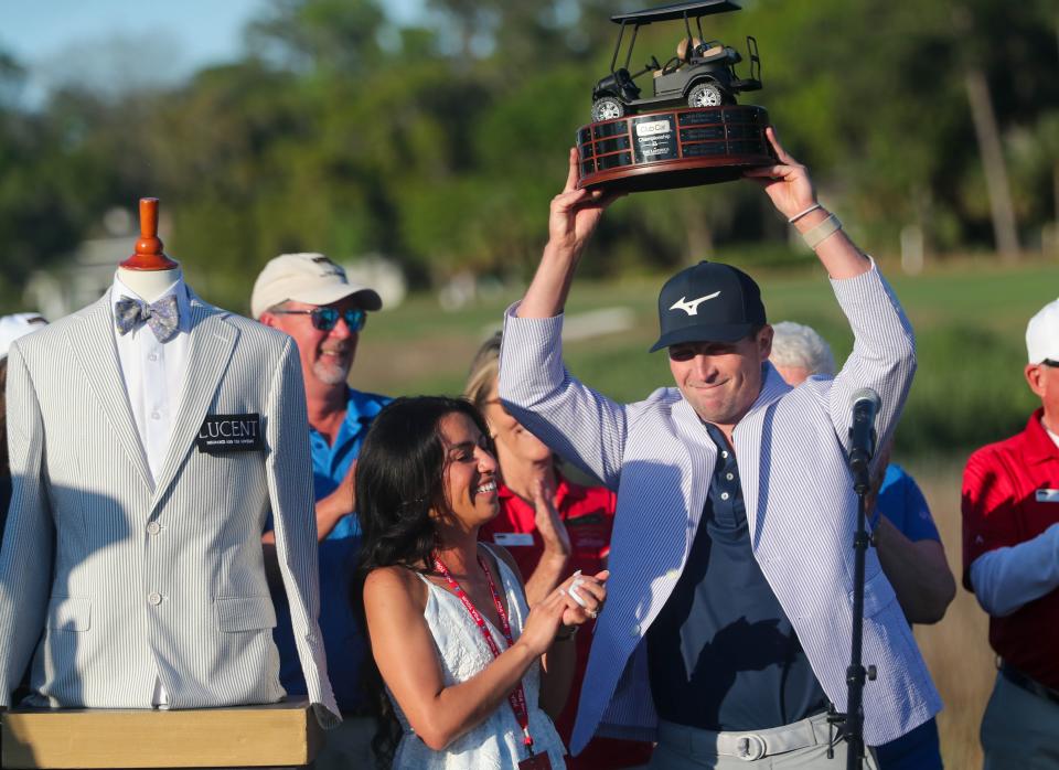 Former Georgia Southern golfer Steven Fisk holds up the championship trophy as he celebrates winning the Korn Ferry Tour Club Car Championship at the Landings Club Deer Creek Course on Sunday, April 7, 2024.