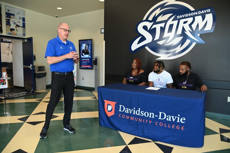 Davidson-Davie Community College Storm men's basketball coach Matt Ridge speaks during the signing ceremony for Uzziah Dawkins.