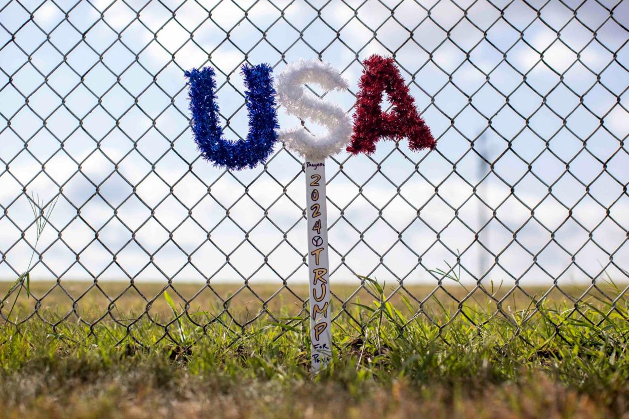 <span>A memorial sign is placed near the site of Trump’s attempted assassination in Butler, Pennsylvania.</span><span>Photograph: Carlos Osorio/Reuters</span>