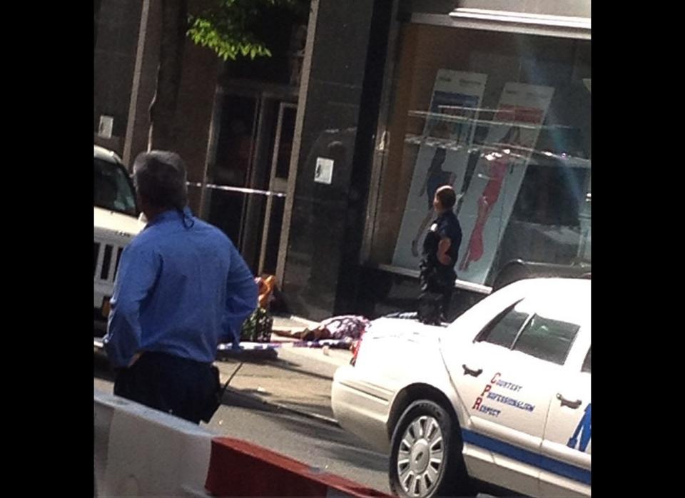 This photo posted to an Instagram account belonging to a person identified as paulnshapiro, an eyewitness at the scene, shows a victim of a shooting, with police standing by, outside the Empire State Building in New York, Friday, Aug. 24, 2012. The identity or condition of the victim was not immediately known. A disgruntled laid-off women's accessories designer shot a former co-worker to death in front of the Empire State Building, causing a chaotic showdown with police in front of one of the world's best-known landmarks. Police killed the suspect and at least nine others were wounded, some possibly by police gunfire, city officials said. The shooting happened at about 9 a.m. Friday at 34th Street and Fifth Avenue. (AP Photo/paulnshapiro via Instagram)