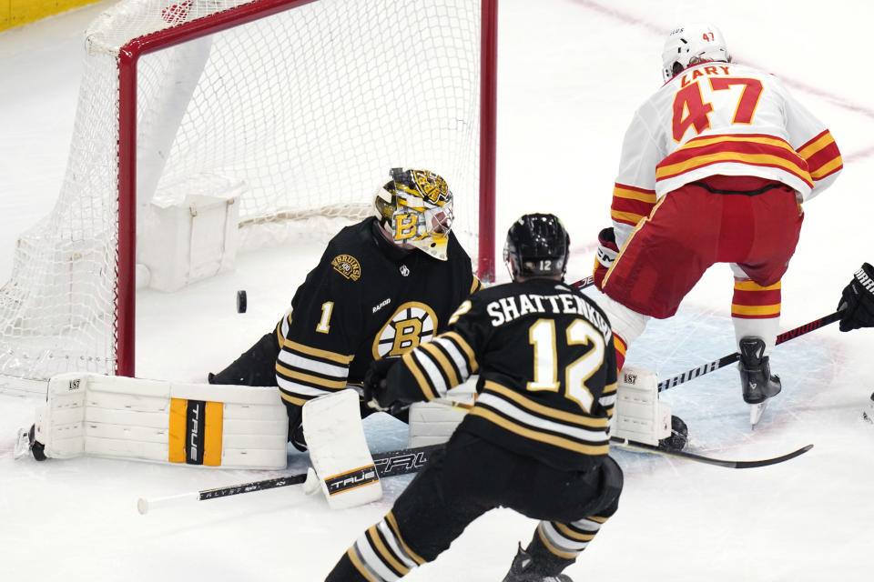 Calgary Flames center Connor Zary (47) beats Boston Bruins goaltender Jeremy Swayman (1) for a goal during the first period of an NHL hockey game, Tuesday, Feb. 6, 2024, in Boston. (AP Photo/Charles Krupa)
