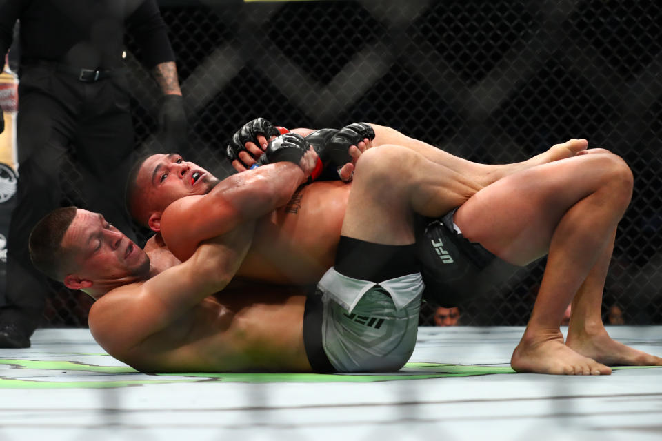 ANAHEIM, CALIFORNIA - AUGUST 17: Nate Diaz and Anthony Pettis fight from the ground in the first round during their Welterweight Bout at UFC 241 at Honda Center on August 17, 2019 in Anaheim, California. (Photo by Joe Scarnici/Getty Images)