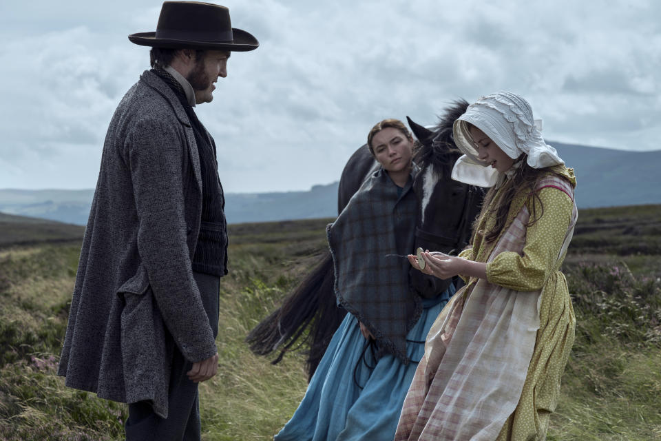 This image released by Netflix shows Tom Burke as Will Byrne, from left, Florence Pugh as Lib Wright, and Kíla Lord Cassidy as Anna O'Donnell in a scene from "The Wonder." (Christopher Barr/Netflix via AP)