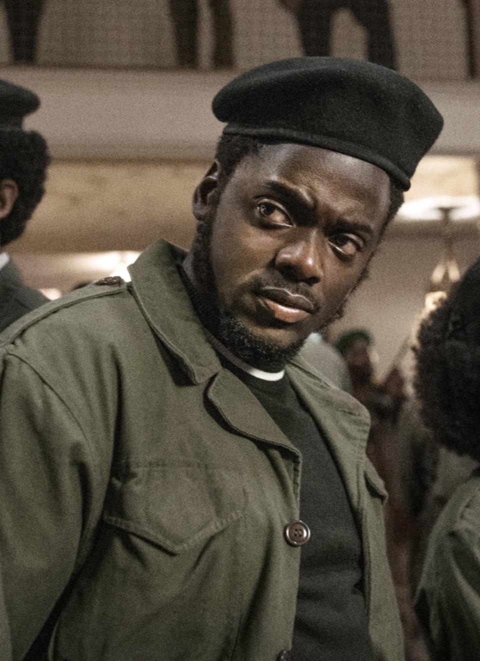 Daniel Kaluuya wearing a black beret hat and army-like jacket