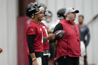 Atlanta Falcons quarterback Desmond Ridder, left, stands next to head coach Arthur Smith during NFL football practice Thursday, May 26, 2022, in Flowery Branch, Ga. (AP Photo/John Bazemore)