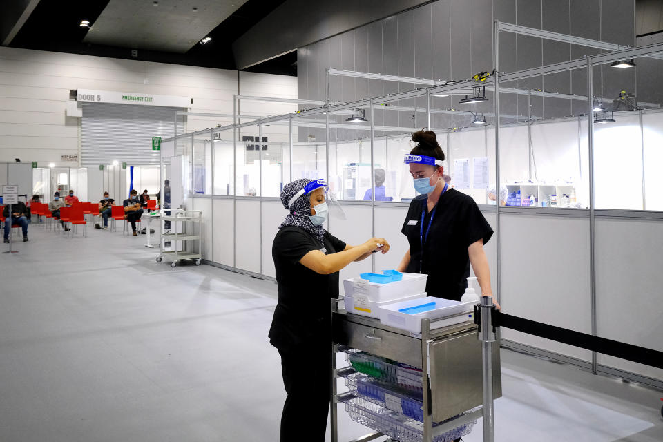 Health workers prepare Pfizer vaccinations at the Melbourne Convention and Exhibition Centre mass vaccination hub in Melbourne.