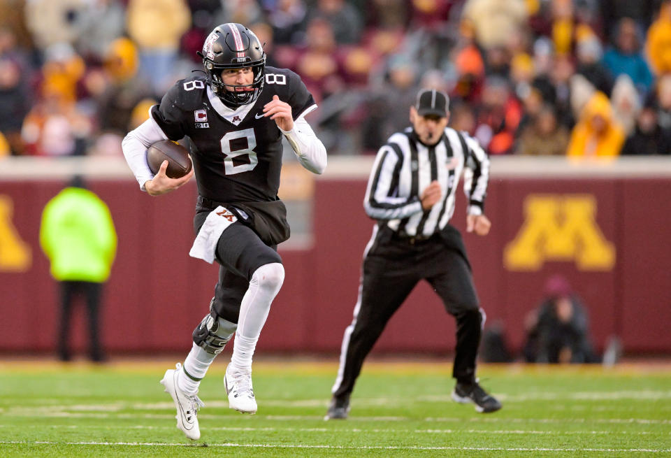 Oct. 28, 2023; Minneapolis, Minnesota; Minnesota Golden Gophers quarter back Athan Kaliakmanis (8) runs for a first down against the Michigan State Spartans during the fourth quarter at Huntington Bank Stadium. Nick Wosika-USA TODAY Sports