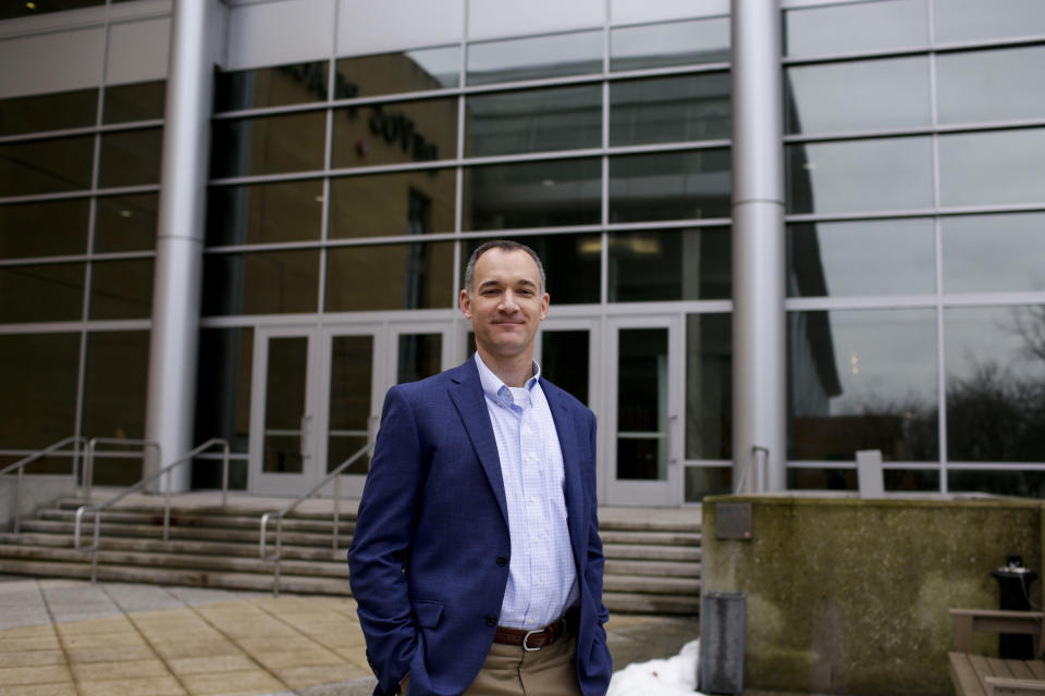 Charles Kroll, CFO of Crystal Flash, an employee-owned fuel distribution company, poses for a portrait outside of DeVos Place convention center during the annual State of Grand Rapids Business event on Jan. 31, 2024, in Grands Rapids, Mich. Kroll said he’s worried about the impact of President Joe Biden’s climate policies — he calls it the president's “war on oil and gas.” Kroll voted for Donald Trump in 2016, Biden in 2020 and is undecided this time. (AP Photo/Kristen Norman)