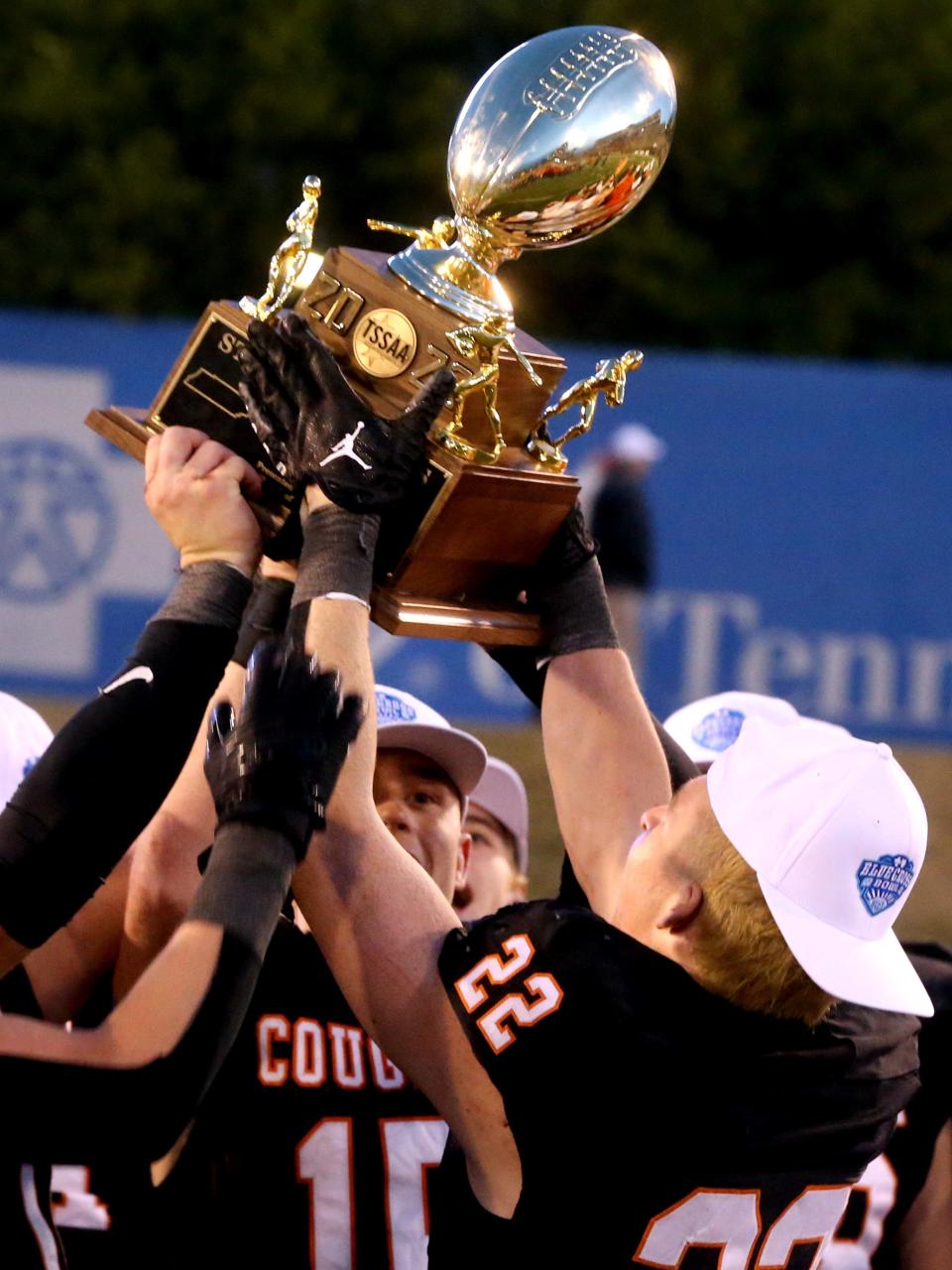 MTCS’ Yates Geren (15) and MTCS’ Eli Wilson (22) raise up the TSSAA BlueCross Bowl Division II-A Championship trophy after defeating Friendship Christian 28-13 during the Championship game at Finley Stadium in Chattanooga, Tenn. on Thursday, Nov 30, 2023.