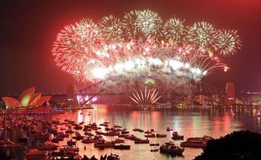 A kaleidoscope of fireworks designed by Marc Newson explode over the Sydney Opera House and the Sydney Harbour Bridge. The 12-minute pyrotechnic display drew more than 1.5 million people to crowded foreshores and city landmarks