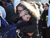 Students are reunited with families at a staging ground set up at the Roswell Mall following an early morning shooting at Berrendo Middle School in Roswell, New Mexico, January 14, 2014. REUTERS/Mark Wilson/Roswell Daily Record