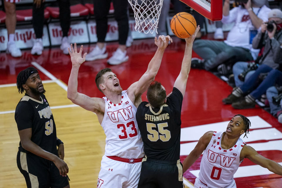 Wisconsin's Chris Vogt (33) blocks a shot by Purdue's Sasha Stefanovic (55) during the first half of an NCAA college basketball game Tuesday, March 1, 2022, in Madison, Wis. (AP Photo/Andy Manis)